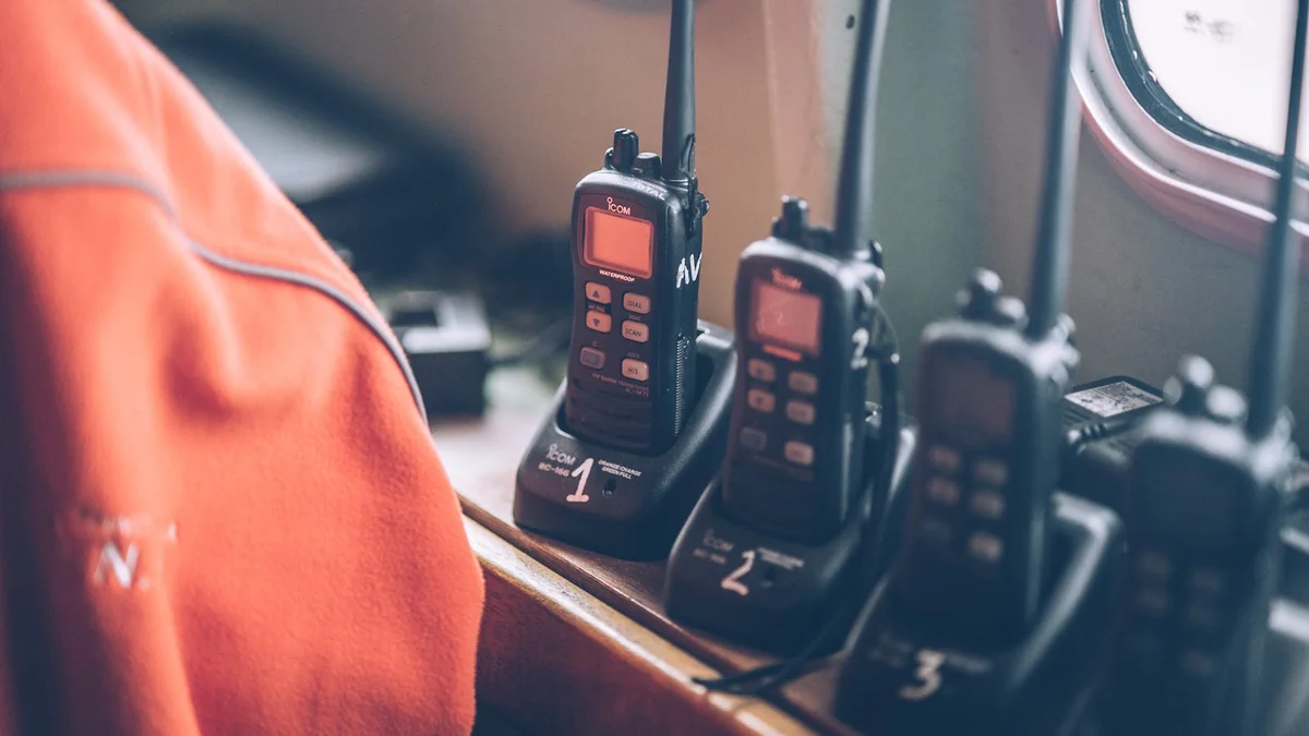 Several two-way radios charging in their docks — a family emergency communication kit ready to go